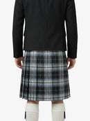 Person wearing a black jacket and plaid kilt on a white background