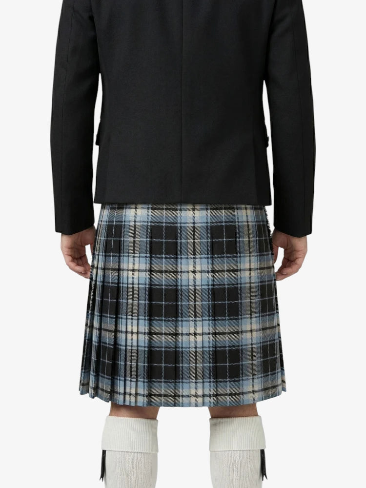 Person wearing a black jacket and plaid kilt on a white background