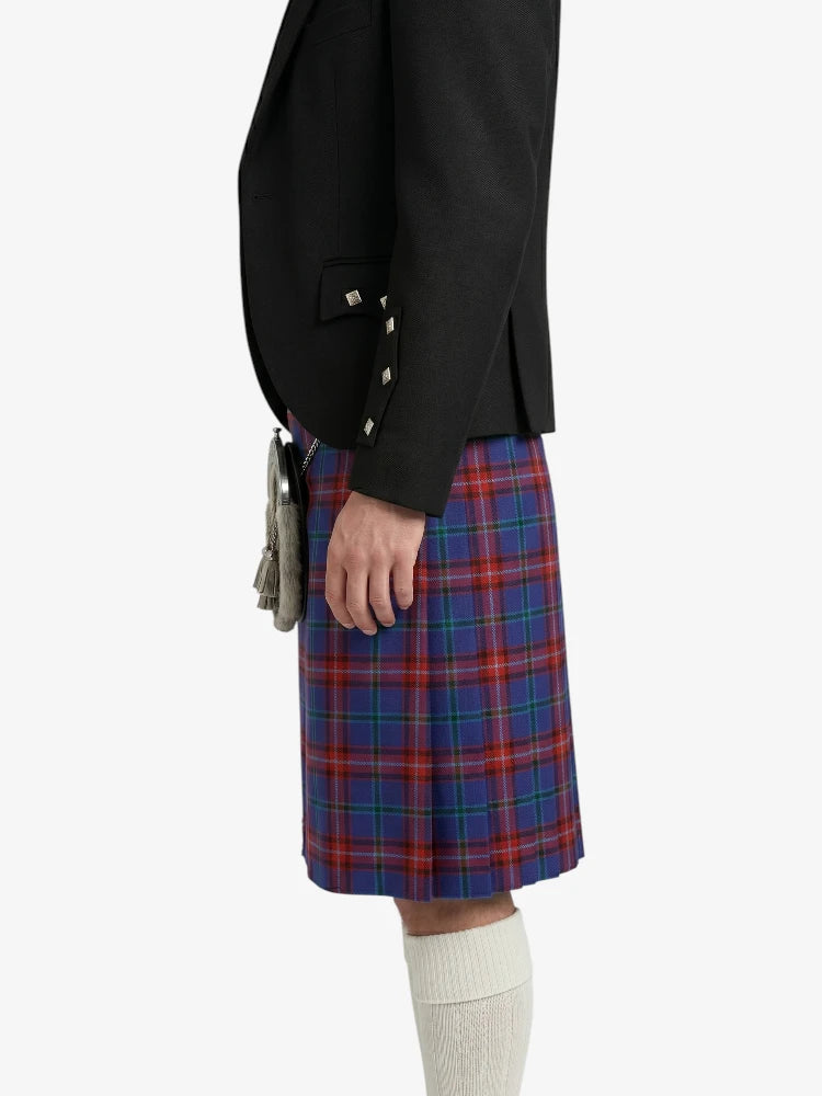 Person wearing a black blazer and red plaid kilt on a white background