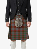 Person wearing a traditional Scottish kilt with a tartan pattern on a white background