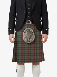 Person wearing a traditional Scottish kilt with a tartan pattern on a white background