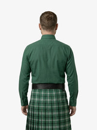 Man wearing a green shirt and green plaid kilt on a white background