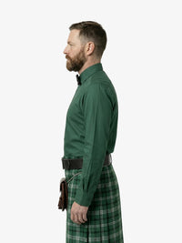 Man wearing a green shirt and plaid kilt on a white background