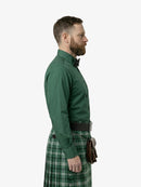 Man wearing a green shirt and plaid kilt on a white background