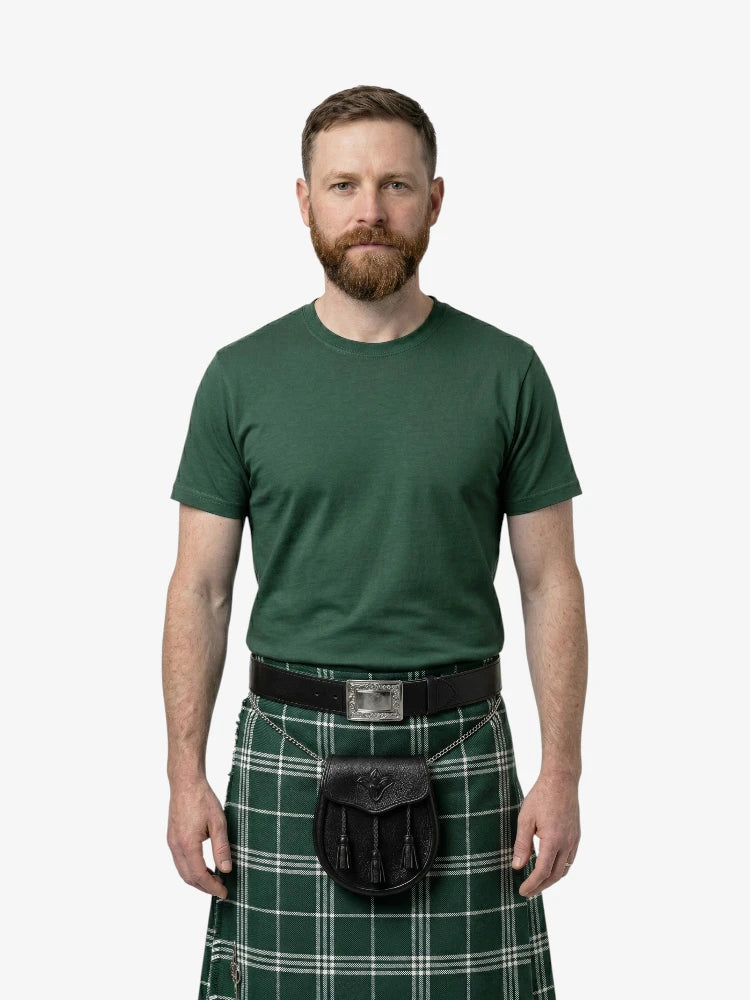 Man wearing a green kilt with a belt on a white background
