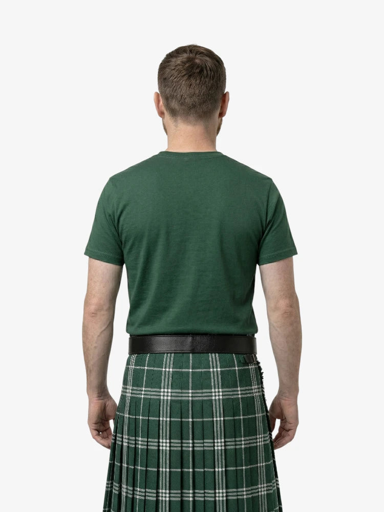 Man wearing a green t-shirt and green plaid kilt on a white background