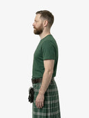 Man wearing a green t-shirt and green plaid kilt on a white background