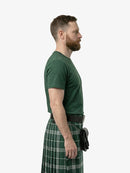 Man wearing a green kilt on a white background
