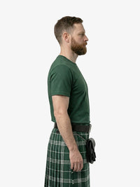 Man wearing a green kilt on a white background