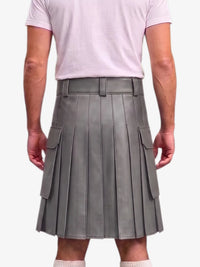 A person shown from the back wearing a gray pleated faux-leather kilt with side cargo pockets, paired with a light pink t-shirt and white socks, against a plain light gray background.
