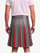 A gray pleated leather kilt with red inner panels and silver-tone decorative buttons, shown on a model from the back wearing a white t-shirt.