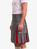 A man wearing a gray faux-leather kilt with red pleated accents and silver hardware, paired with a white t-shirt and white socks, shown from the waist down against a light gray background.