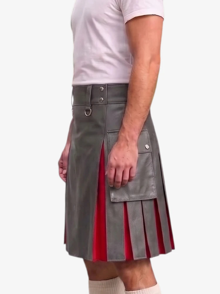 A man wearing a gray faux-leather kilt with red pleated accents and silver hardware, paired with a white t-shirt and white socks, shown from the waist down against a light gray background.