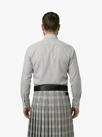Man wearing a light gray shirt and plaid kilt on a white background