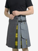 Person wearing a gray kilt with a yellow plaid pattern on a white background