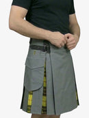 Person wearing a gray kilt with yellow plaid accents on a white background