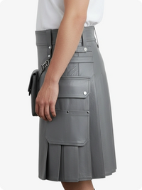 Gray pleated skirt worn by a person on a white background
