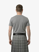 Man wearing a gray t-shirt and a gray plaid kilt on a white background