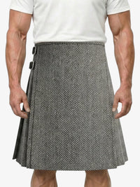 Person wearing a gray herringbone kilt on a white background