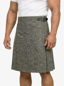 Person wearing a gray herringbone kilt on a white background