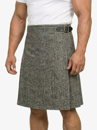 Person wearing a gray herringbone kilt on a white background