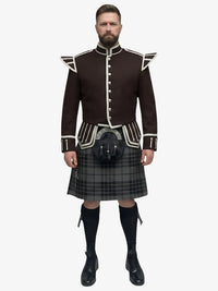 Man wearing a traditional Scottish grey watch tartan kilt with a dark brown jacket on a white background