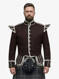 Man wearing a dark brown jacket with white trim and a grey watch tartan plaid kilt on a white background