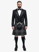 Man wearing a traditional Scottish grey watch tartan kilt with a black prince charlie jacket on a white background