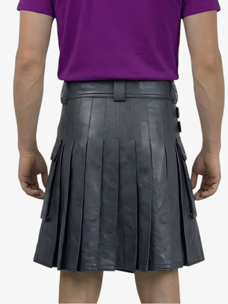 Person wearing a black pleated leather kilt over a purple shirt on a white background