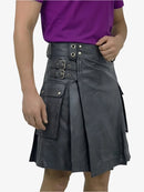 Person wearing a black leather kilt with silver buckles on a white background