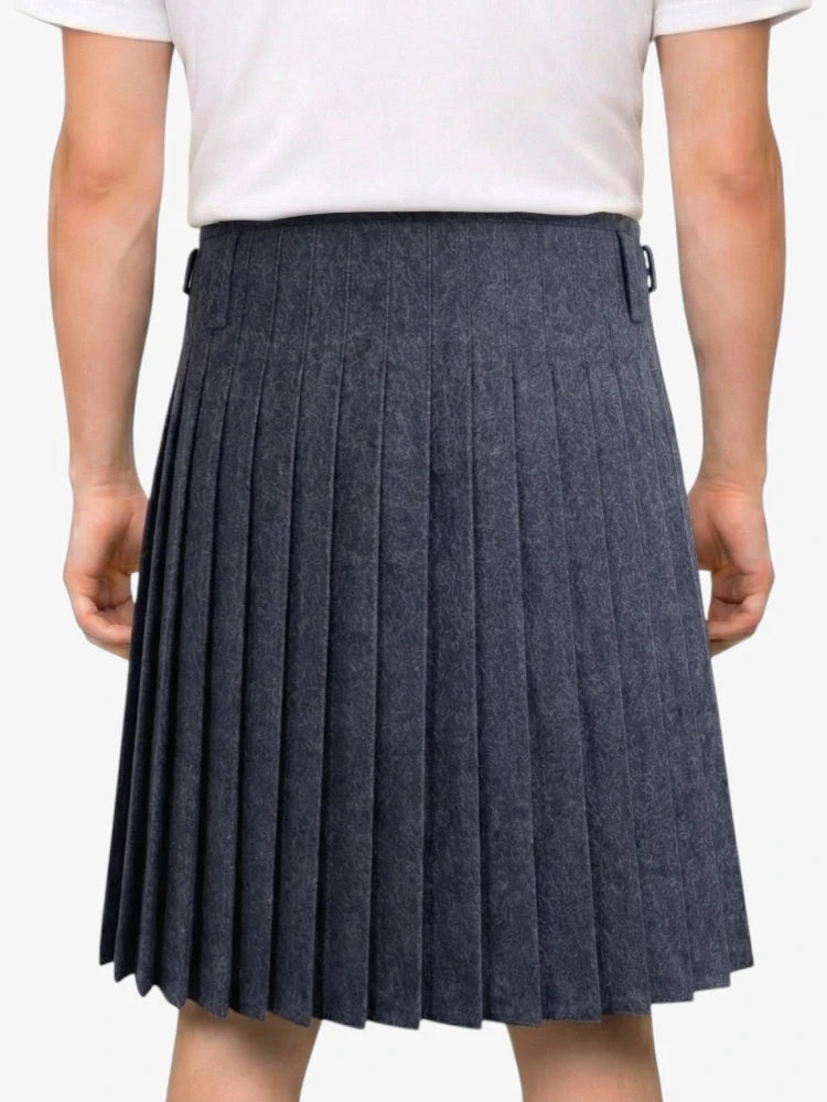 Person wearing a pleated gray skirt on a white background