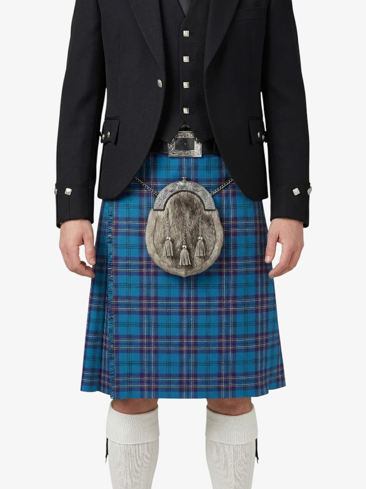 Person wearing a traditional Scottish kilt with a blue plaid pattern on a white background