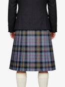 Person wearing a black jacket and plaid kilt on a white background