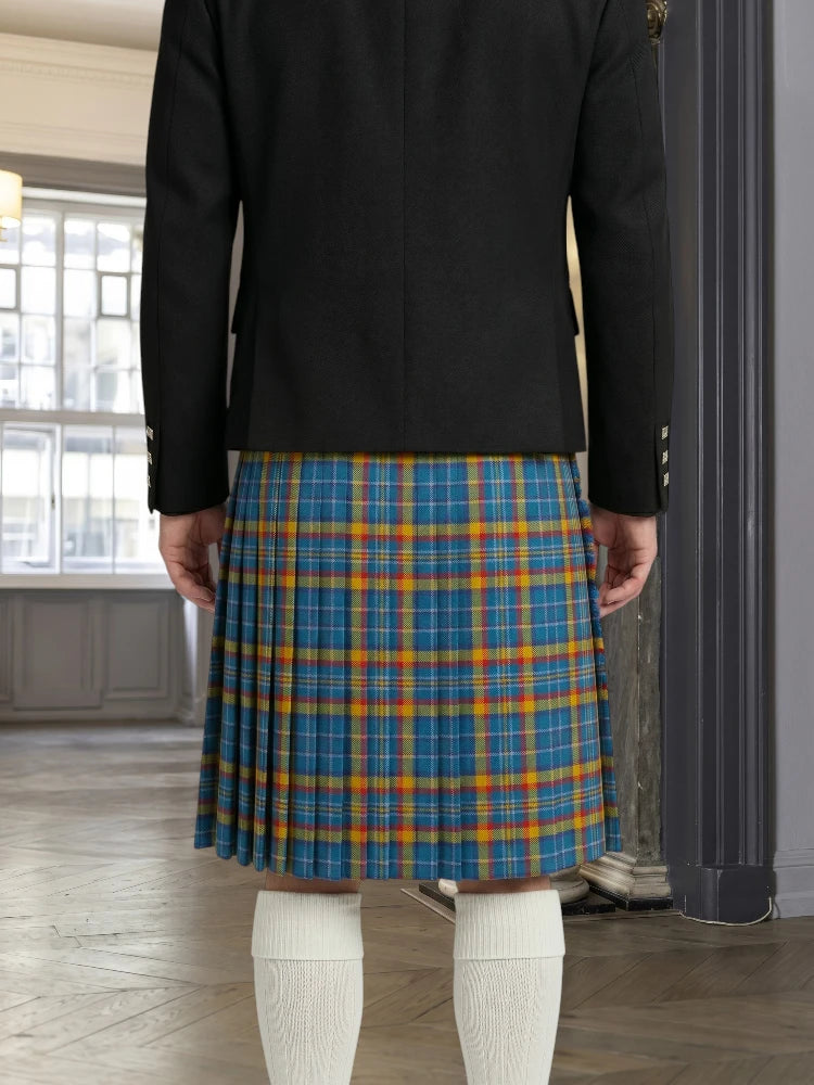 Person wearing a black jacket and blue plaid kilt indoors.
