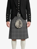 Person wearing a black jacket, gray kilt, and white knee-high socks on a white background