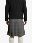 Person wearing a black blazer and gray pleated skirt on a white background