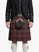 Person wearing a traditional Scottish kilt with a patterned sporran on a white background