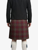 Person wearing a black jacket and red plaid kilt on a white background