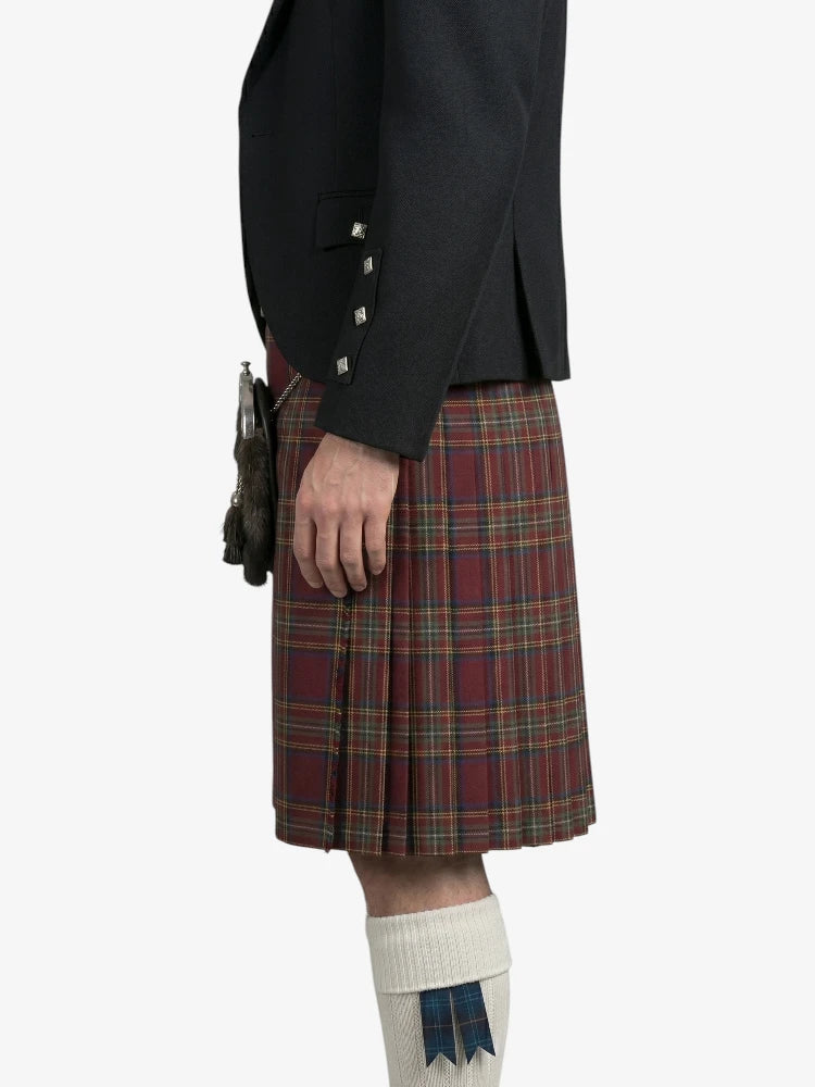 Person wearing a black jacket and red plaid kilt on a white background