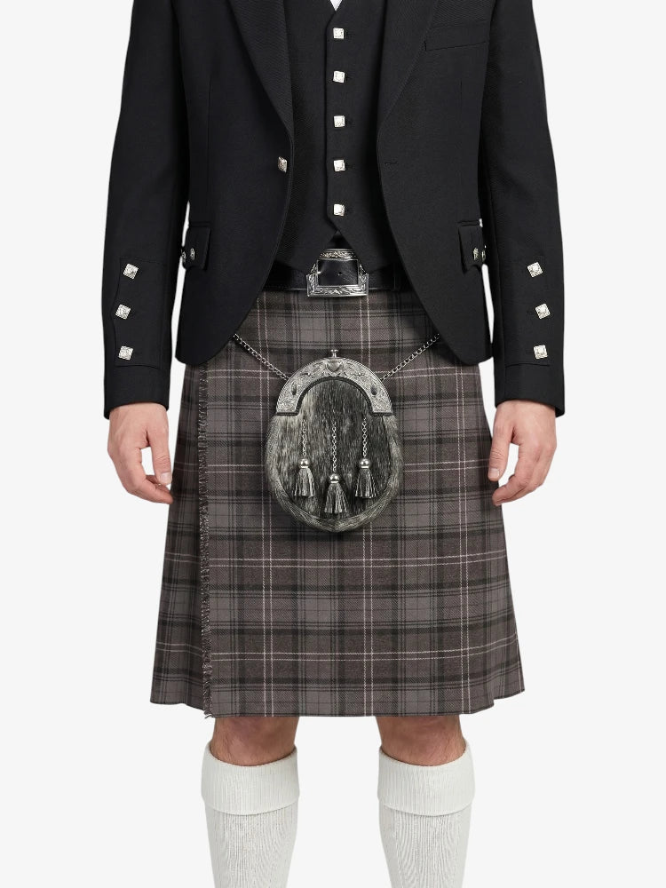 Person wearing a traditional Scottish kilt with a sporran on a white background