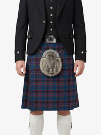 Person wearing a traditional Scottish kilt with a tartan pattern on a white background