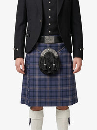 Person wearing a traditional Scottish kilt with a sporran on a white background
