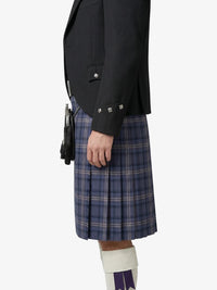 Person wearing a dark jacket and plaid kilt on a white background