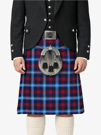Person wearing a black jacket and red and blue plaid kilt with a silver sporran on a white background