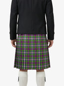 Person wearing a black jacket and green plaid kilt on a white background