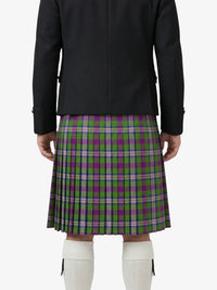 Person wearing a black jacket and green plaid kilt on a white background