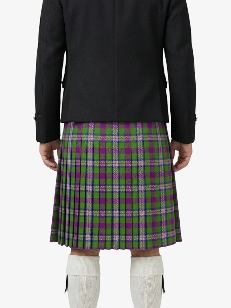 Person wearing a black jacket and green plaid kilt on a white background