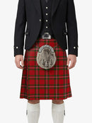 Person wearing a red tartan kilt with a black jacket on a white background
