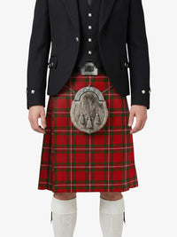 Person wearing a red tartan kilt with a black jacket on a white background