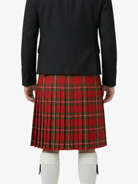 Person wearing a black jacket and red plaid skirt on a white background